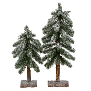 Two flocked artificial pine trees of different heights on wooden bases, isolated on white.
