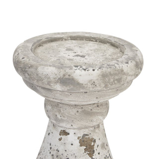 Close-up detail of the round platform top of the ceramic candle holder, showing the rough, distressed grey and white finish.