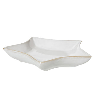 Front view of the small white star-shaped dish, highlighting the shallow bowl depth and rustic rim.