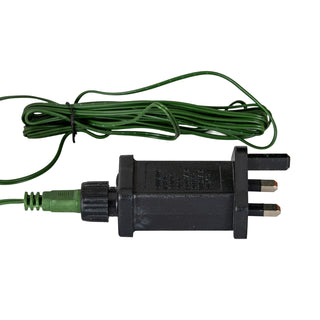 Black UK 3-pin plug and transformer unit connected to the green power cable for the pre-lit LED lights.