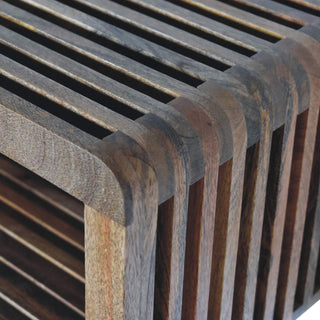 Curved corner detail showing how the individual wooden slats form the continuous top and side surfaces.