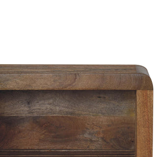 Close-up detail of the curved corner and rich wood grain texture of the bedside unit.