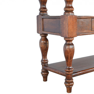 Detail of the turned wood legs, lower shelf, and dark wood grain finish.