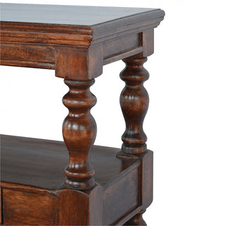 Detail showing the turned supports joining the dark wood tabletop and the lower shelf.