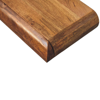 Rich brown wood grain texture visible on the console table top, focusing on the thick, rounded corner joint.