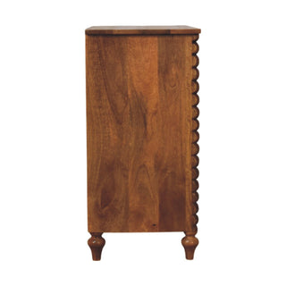 Side profile of the mango wood chest, showing the wood grain, turned feet, and the bobble spindle column.