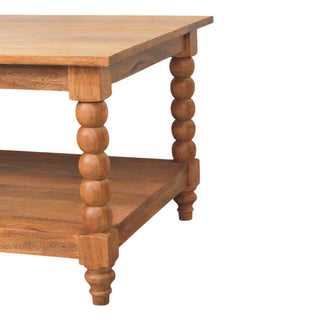 Detail of the bobbin turned legs supporting the tabletop and the lower shelf of the coffee table.