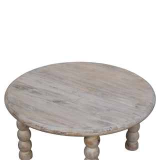 Overhead view of the round salted oak tabletop showing the distressed wood grain.