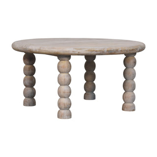 Salted oak coffee table showing the distressed whitewash finish and turned bobbin legs.