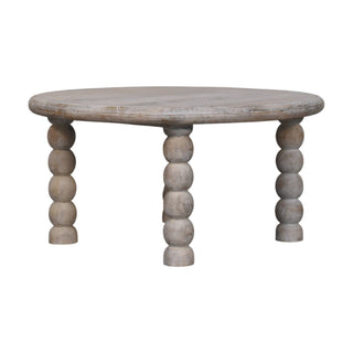 Round salted oak coffee table with four substantial turned bobbin legs, viewed from the front and isolated on white.