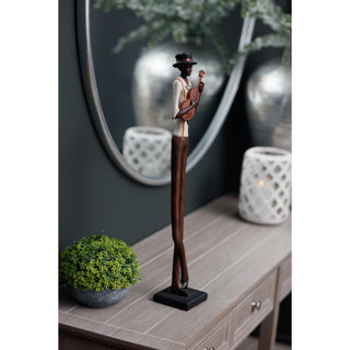 Figurine displayed on a wooden console table next to a mirror, showing its height and slender form.