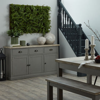 The stone ceramic vase displayed with a smaller matching vase on a wooden sideboard in a styled interior.