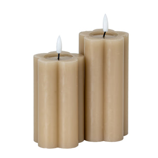 Pair of stone-coloured LED candles, one taller than the other, showing the fluted sides and lit wicks.
