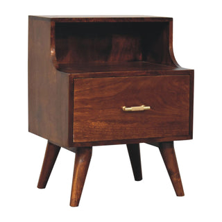Dark wood bedside cabinet shown at an angle, highlighting the mid-century tapered legs and curved raised back.