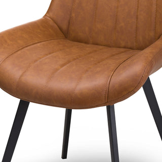 Close-up detail of the tan faux leather chair seat showing parallel stitching lines and the texture of the material.