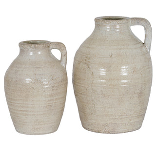Medium and large ceramic jugs with rustic cream glaze and handles, shown side-by-side for scale comparison.