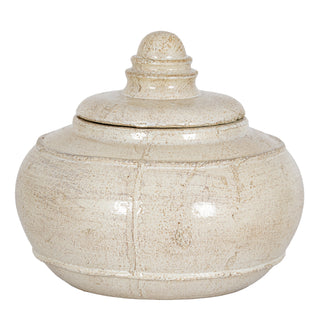Round decorative pot with lid and finial, featuring a distressed, textured cream glaze. Plain studio shot.