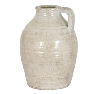 Plain front-on studio shot of a medium ceramic jug with a handle and textured, rustic cream glaze.
