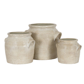 Three pale textured ceramic pots displayed together, showing the small, medium, and large sizes in the range.