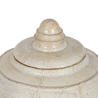 Close-up detail of the pot lid and finial, showing the heavily distressed cream glaze texture.