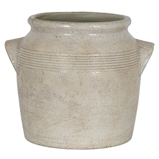 Full view of the off-white ceramic pot showing the mottled, textured surface and slight glaze finish.