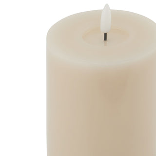 Close-up detail of the taupe flameless candle showing the recessed melt effect and the LED flame.