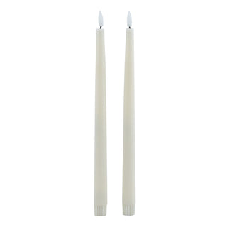 Plain front-on view of two taupe flameless dinner candles with illuminated LED flames.