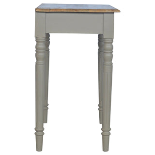End profile of the taupe desk, highlighting the natural wood top and the pair of fluted legs.
