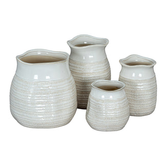Display of four textured white ceramic vases in varying heights and widths.