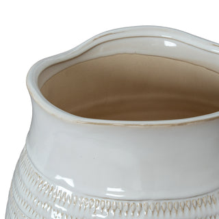 Close-up of the wavy rim and smooth glazed neck, showing the beige interior and the textured pattern below.