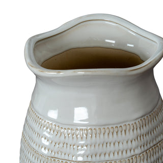 Close-up of the wavy rim and the textured, droplet-like pattern on the white glazed ceramic vase body.