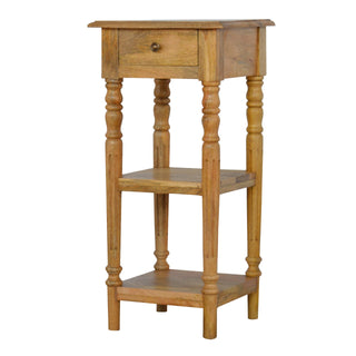 Narrow wooden end table with a top drawer, two lower shelves, and four detailed turned legs.