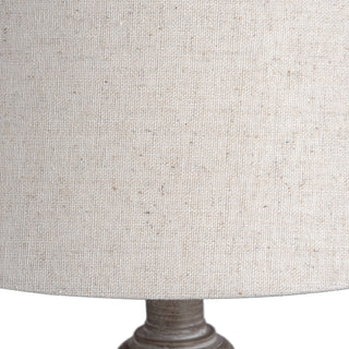 Close detail of the pale fabric lamp shade showing the coarse weave texture and natural flecks.