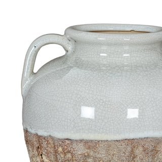 Detail of the white crackle glaze meeting the rough, ribbed brown ceramic base, showing a handle.