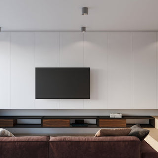 Grey ceiling lights installed in a modern living room above a television and floating media unit.