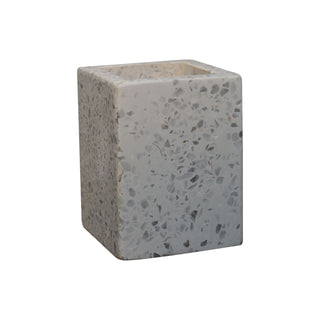 Square toothbrush holder in light grey speckled terrazzo, isolated on white background.
