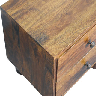 Close-up detail of the chestnut wood grain on the top and side panels of the nightstand.