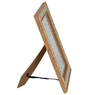 Side profile of the wood-effect frame standing upright, showing the extended easel support and retaining strap.