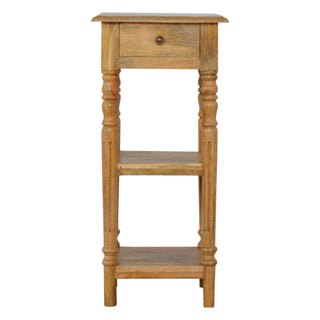Front view of narrow wooden telephone table with turned legs, a single drawer, and two lower shelves.