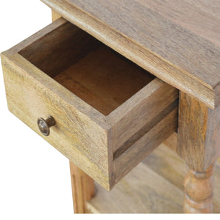 Open drawer detail showing the wooden box construction and interior grain, with antique brass pull.