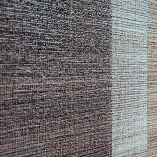 Extreme close-up highlighting the thick, raised, horizontal texture of the brown and beige paint blocks.