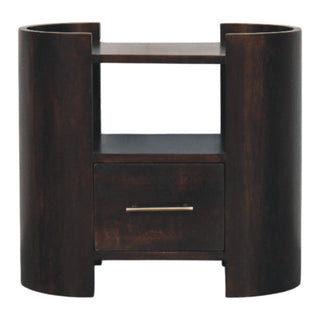 Front view of a dark wood bedside table with curved side panels, an open shelf, and a drawer with a brass handle.
