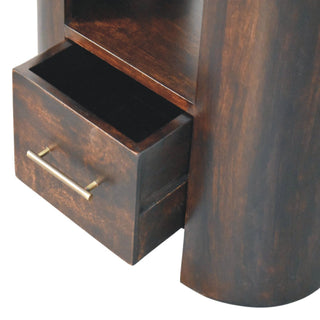 Close up of the dark wood drawer of the bedside table pulled open, showing the interior and brass bar handle.