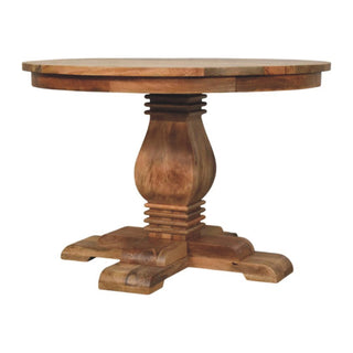 Round wooden dining table featuring a bulbous turned pedestal resting on four substantial cross feet.
