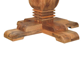 Close detail of the square, stepped base section where the turned pedestal meets the four substantial cross feet.