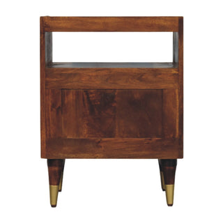 Back view of the dark mango wood bedside table, showing the solid panel, open shelf, and tapered legs.
