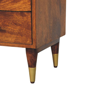 Close-up detail of the tapered mango wood legs with polished brass metal tips.