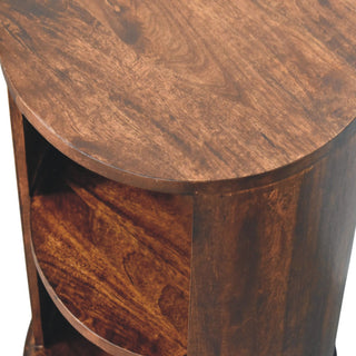 Detail shot of the Ventura side table's curved top surface and the wood grain on the internal shelf.