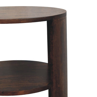 Close detail of the dark wood grain and curved edge of the Ventura side table structure and shelves.