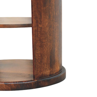 Detail of the Ventura side table's lower shelf, curved exterior panel, and the raised circular plinth.
